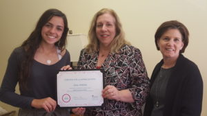 Alina DiMella of Brewster, a Girl Scout, receives a certificate of appreciation from Katherine Quinn, Support Connection Executive Director, and Robin Perlmutter, Support Connect